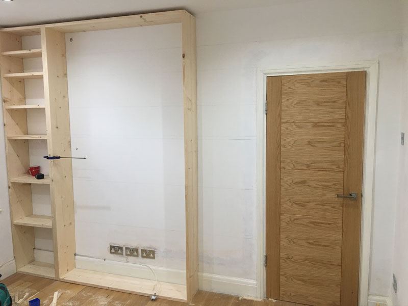 Wall of shelves during the build