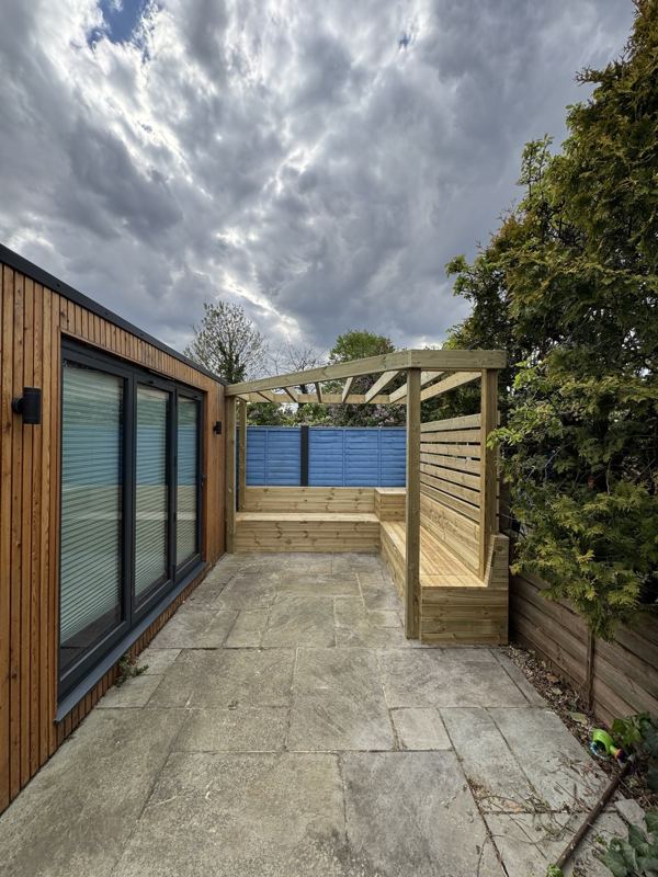 The finished benches and pergola seen from across the patio