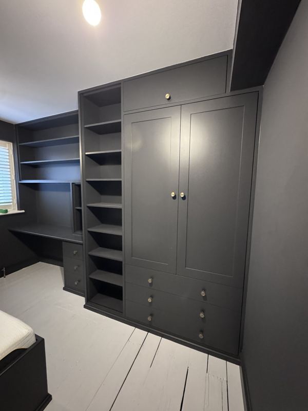 Fitted dark grey wardrobe, shelving tower and built-in desk in a kids' bedroom in Walthamstow