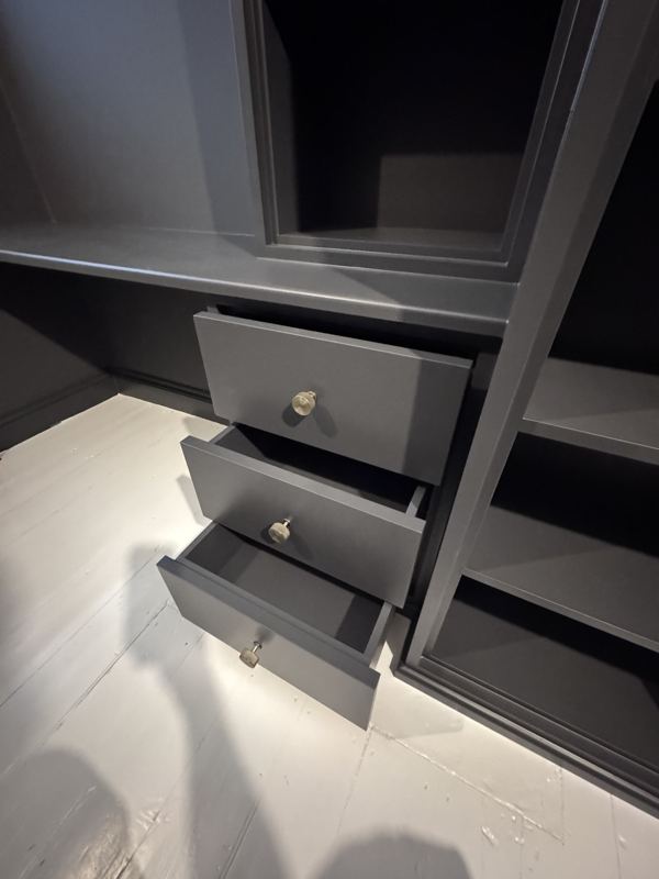 Desk drawers open, painted dark grey with brass knobs