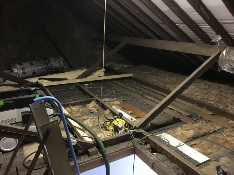 Boarded storage platform in a loft with insulation around it