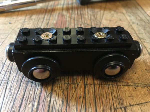 Lego screwed to the wooden train base