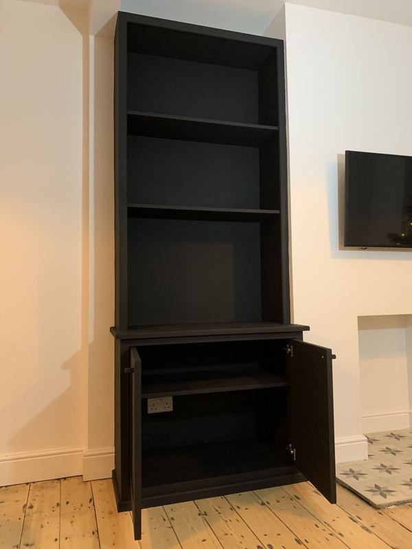 Alcove cupboard doors open, showing the shelf inside